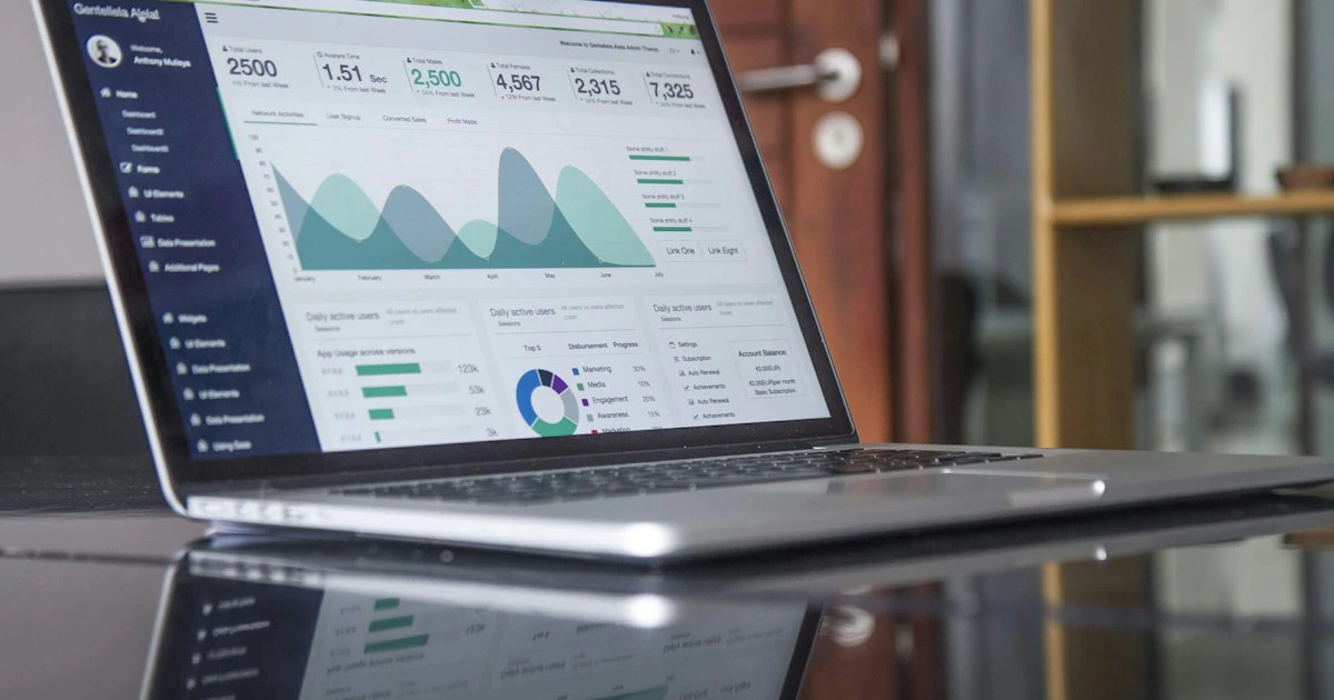 Modern laptop displaying a website analytics dashboard on a clean workspace