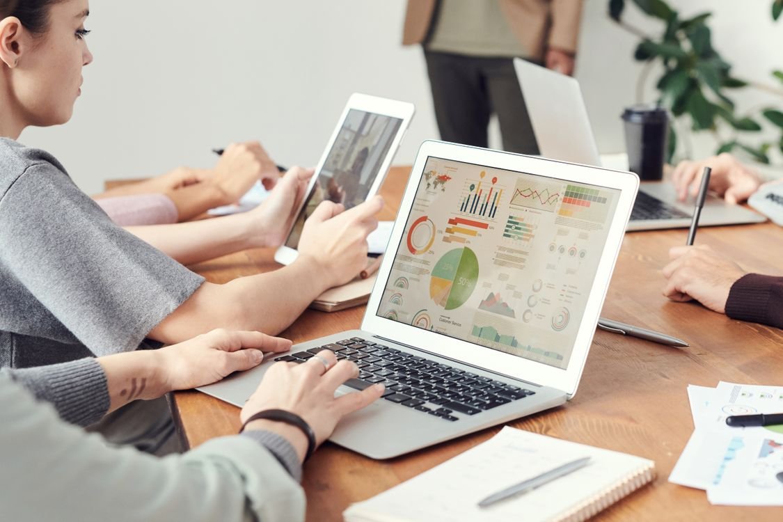 A marketing professional works on campaign planning at a laptop in a modern office