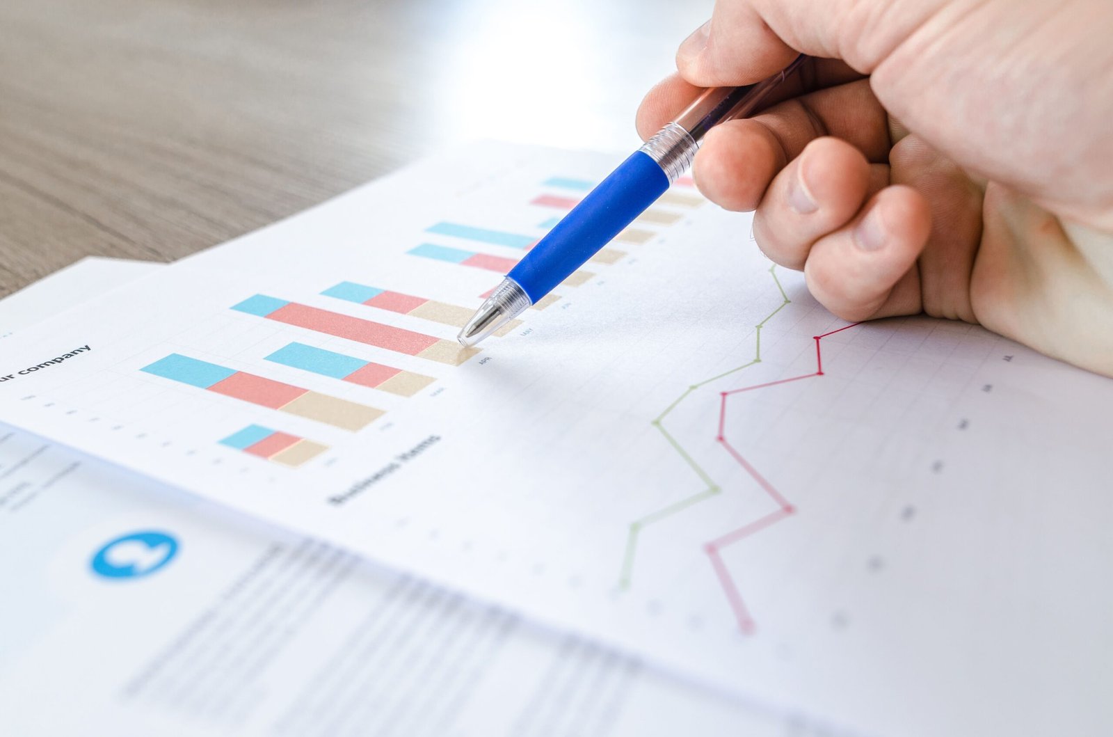 Person reviewing marketing growth charts and performance metrics