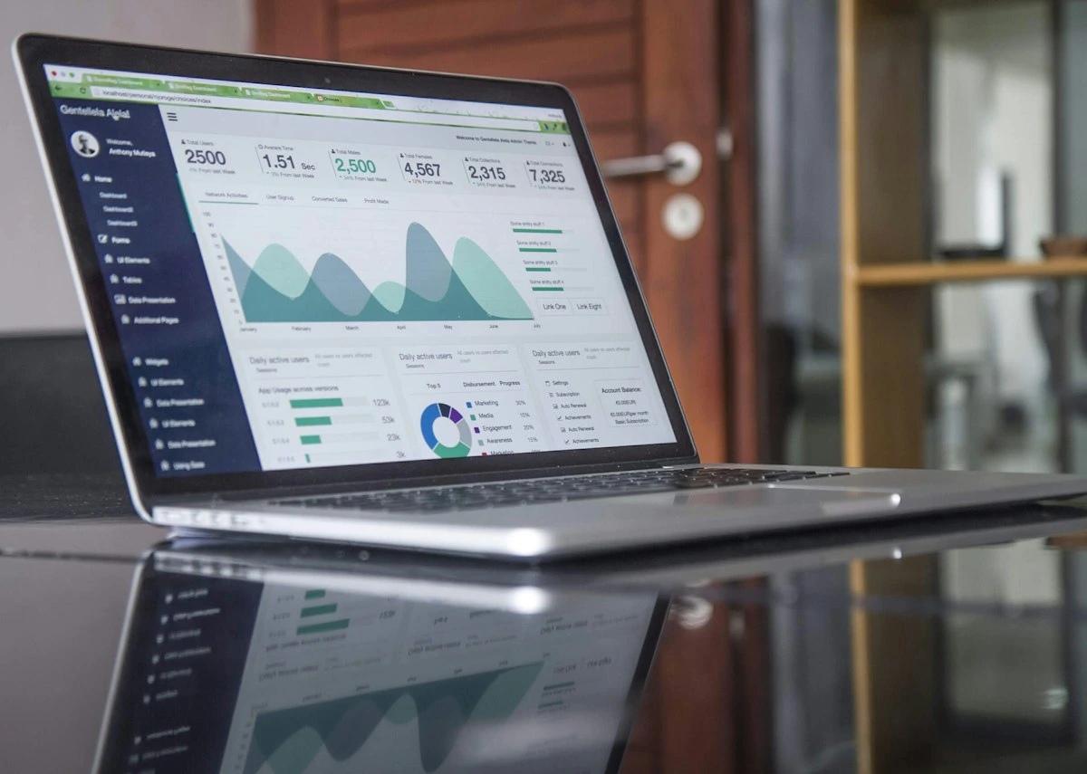 Laptop displaying an analytics dashboard with colorful data charts and metrics for SEO performance tracking